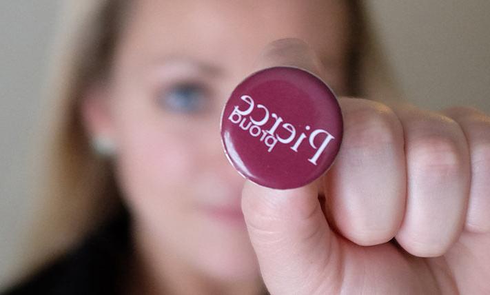 Student holds Pierce Proud button